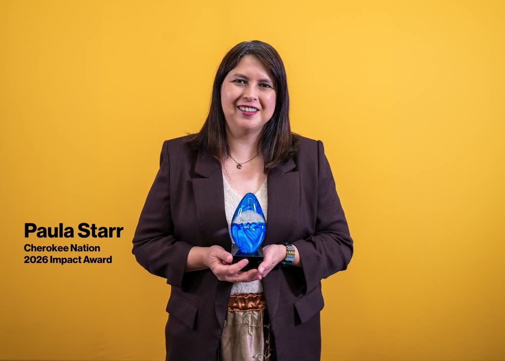 Portrait of Paula Starr, Cherokee Nation, holding her 2026 Impact Award against a gold backdrop